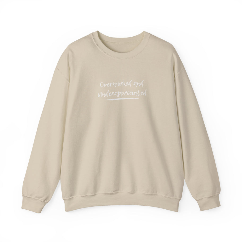 Beige sweatshirt with 'overworked and underappreciated' text on a white background