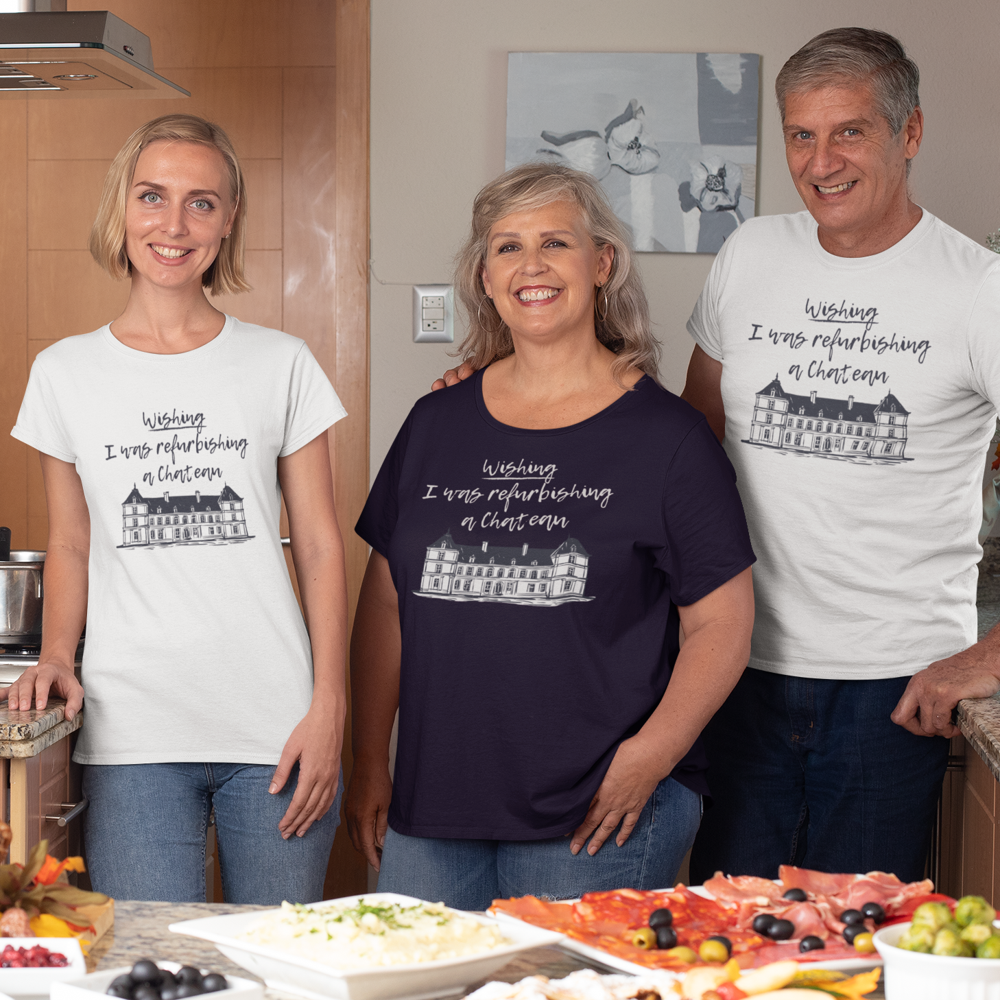 Three people wearing t-shirts with a similar design in a kitchen setting.