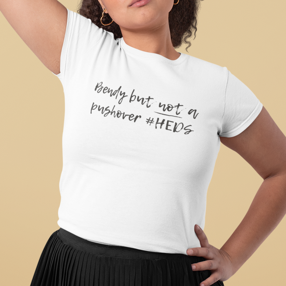 A person wearing the "Bendy But Not A Pushover" shirt. Relaxed-fit, soft apparel for Spoonies and Zebra warriors who need comfort during a flare-up.
